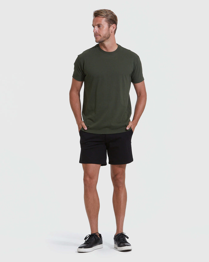 Man wearing Black Commuter Short with hands in pockets, casual stance.