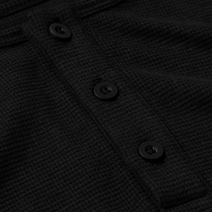 Close-up of the black textured waffle fabric and black buttons on the Black Waffle Long Sleeve Henley 3-Pack, showing details of men's basics style.