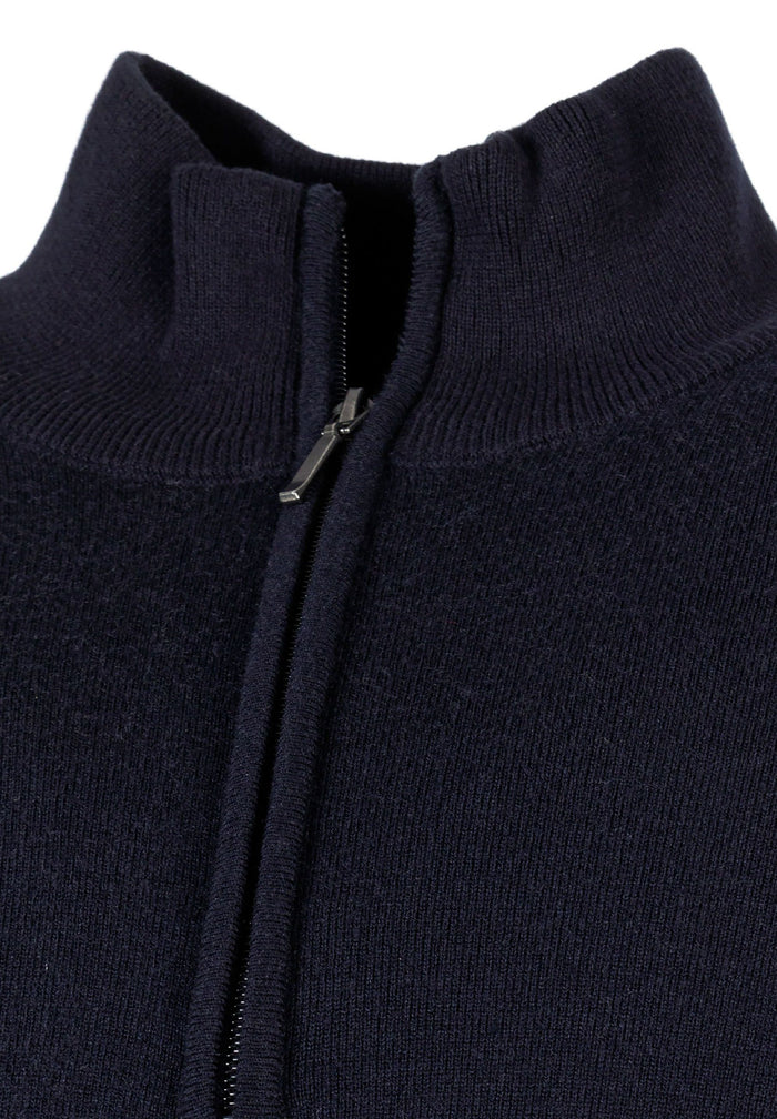 Close-up of a navy men's half zip jumper with a high collar and zip fastening.