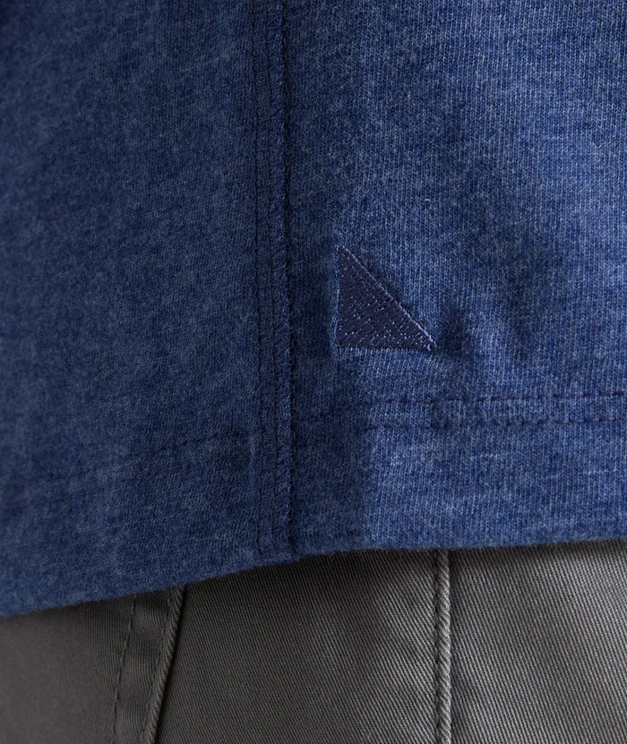 Model is wearing UNTUCKit Jericho henley in solid blue.