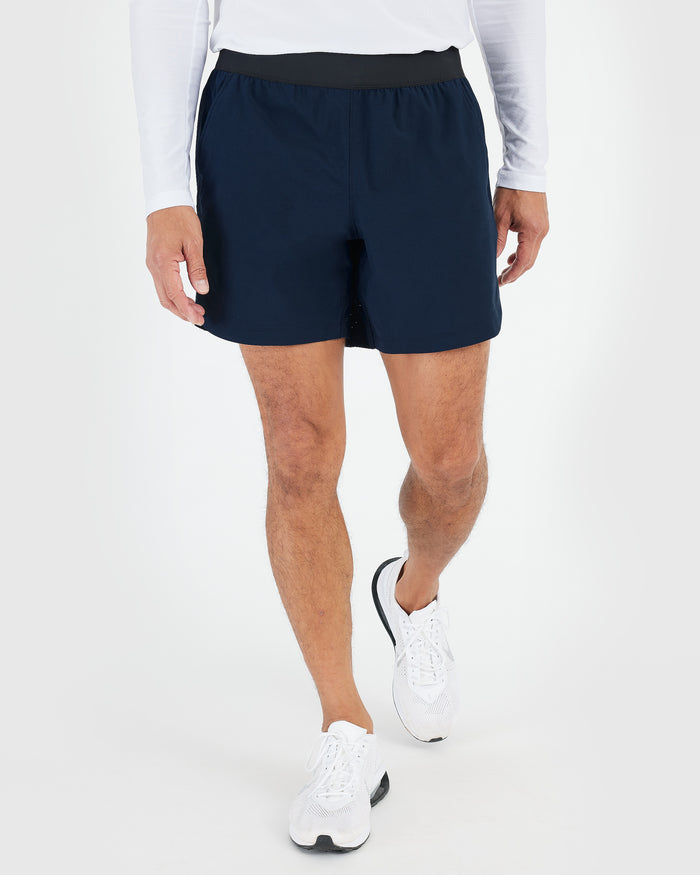 Active Crew & Training Short 8-Pack worn, showcasing navy shorts and running shoes.