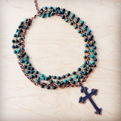 Necklace with turquoise beads and a cross pendant.