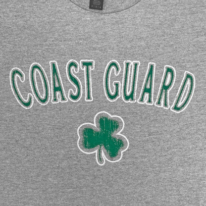 Gray t-shirt with 'COAST GUARD' text and shamrock design on a plain background