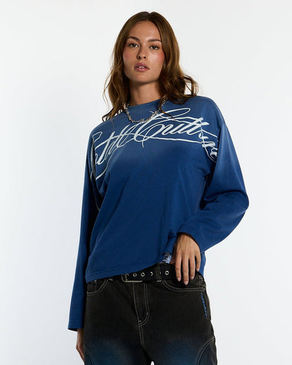 CROSSED SCRIPT LONGSLEEVE VIBRANT BLUE - washed blue script print longsleeve tee, front view on female model - Cold Culture #woman
