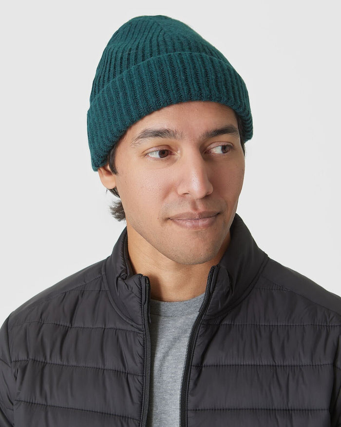 Evergreen Sweater Beanie on young man, showcasing its cozy, rib-knit design.