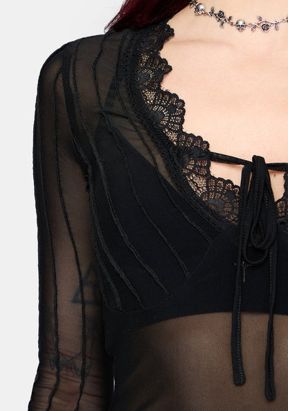 Black lace detail top with sheer sleeves on a white background