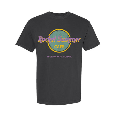 A black Comfort Colors T-shirt by The Rocket Summer, garment-dyed with a retro circular café logo in purple and yellow, featuring “Florida • California” beneath.