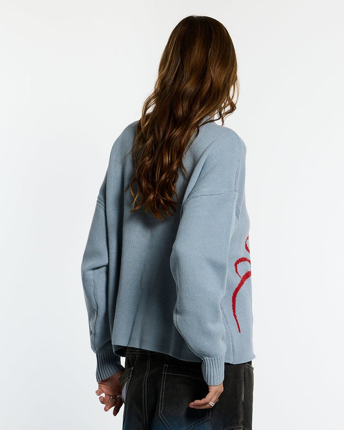 SPIDER KNIT LIGHT BLUE - light blue spider print knit sweater, back view on female model - Cold Culture #woman