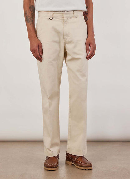 A model wears the Percival Stay Press Trousers in ecru cotton twill.