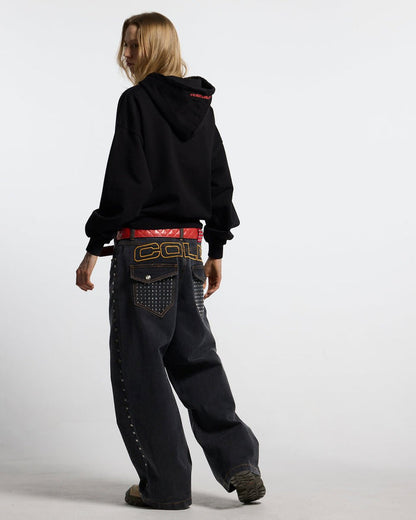 STUDS PANTS BLACK DENIM - black studded denim pants, back view on female model - Cold Culture #woman