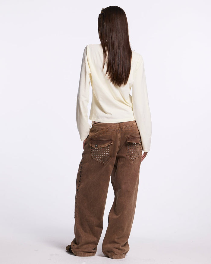 STUDS PANTS BROWN DENIM - brown studded denim pants, back view on female model - Cold Culture
