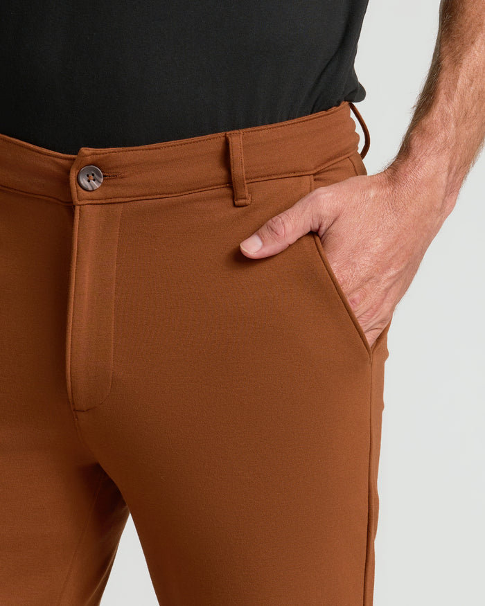 Suede Brown Slim Comfort Knit Chino Pant with hand in pocket.