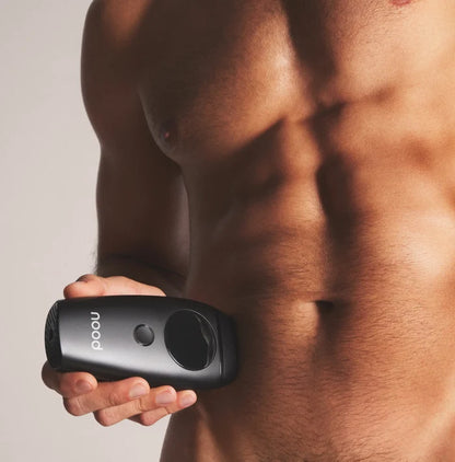 Man holding Nood Flasher IPL device against torso showing at-home hair removal for men