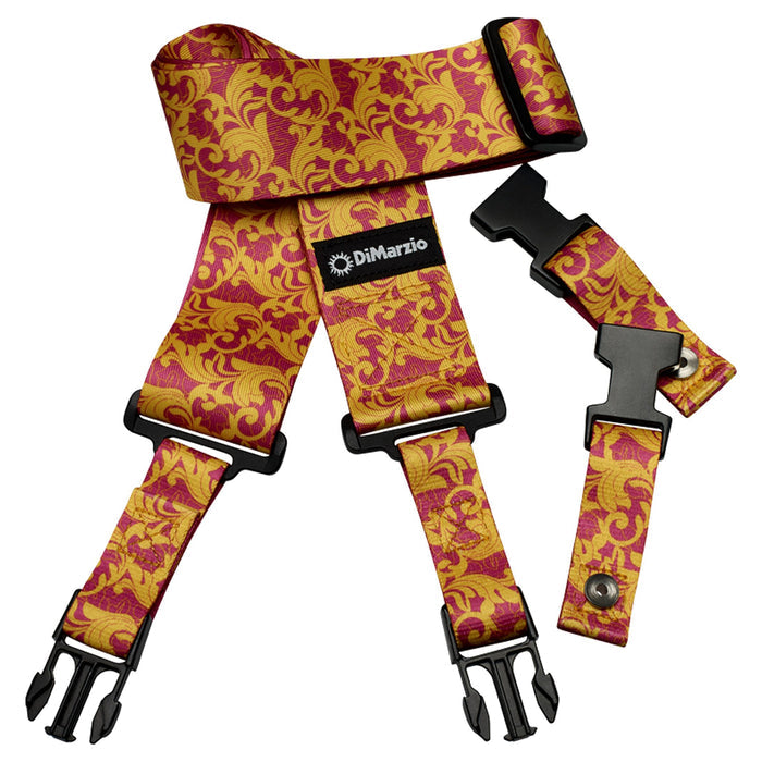 Image of a clip lock guitar strap against white background. the guitar strap clips together with black clips and has a small black patch that says "DiMarzio". the strap is pink and gold and a leafy pattern.