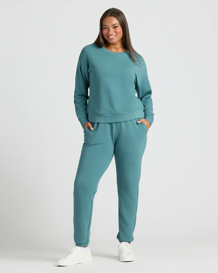 Wearing Womens Stormcloud Slouch Pullover Crew with matching joggers and sneakers.