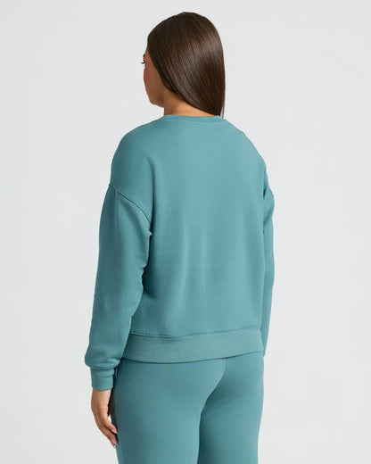 Back view of woman in Womens Stormcloud Slouch Pullover Crew & Relaxed Jogger set.