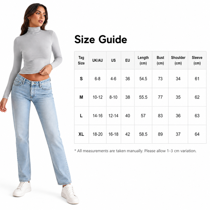 Woman wearing a gray long-sleeve top and light blue jeans with a size guide on a white background.