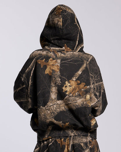 ZIP HOODIE REALTREE BLACK - black camo zip-up hoodie, back view on female model - Cold Culture #woman